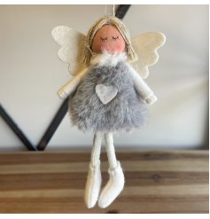 Sure to add an angelic hint to your tree display at Christmas, a faux fur bodied fabric angel with grey and white tones 