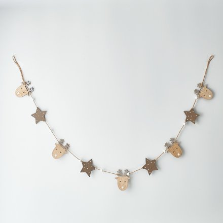 Perfect for adding calming and neutral tones to your home, a wooden garland with reindeer and trees strung across it 