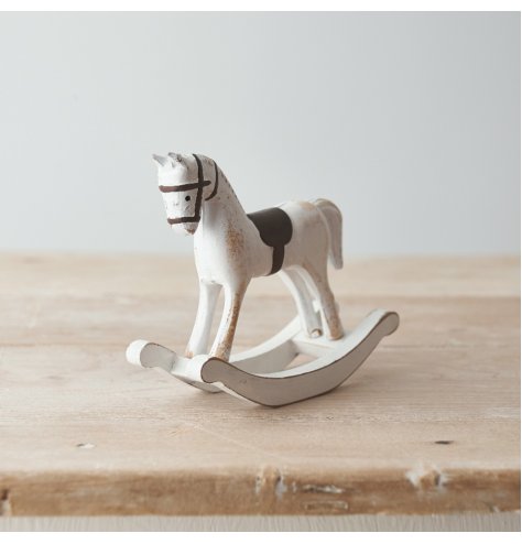 A chic and simple wooden based rocking horse with a distressed white finish 