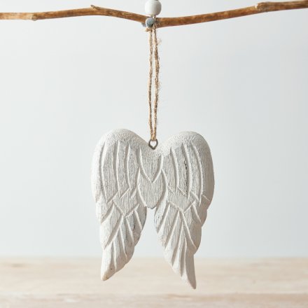 A chunky pair of wooden angel wings hung from a jute string, complete with an overly distressed finish and white wash to