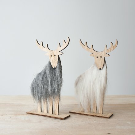 An assortment of natural wood based reindeer with faux fur accents and a grey and white tone to each 