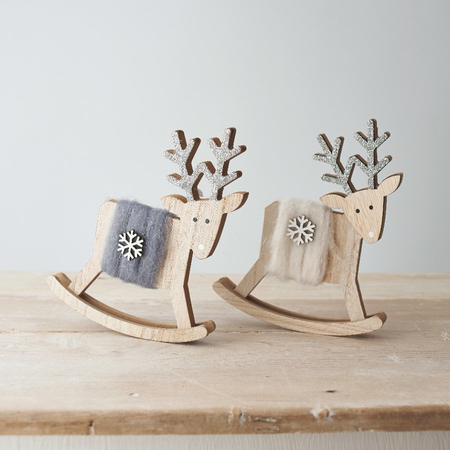  An assortment of natural wood based reindeer rockers with woollen accents and added glittery touches 