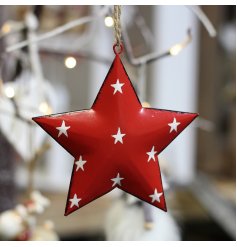 A red toned metal hanging star with an overly distressed design and added white starry print to finish 