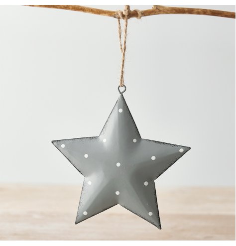 A hanging metal star covered with a soft grey tone, distressed edge finish and added white dotty print 