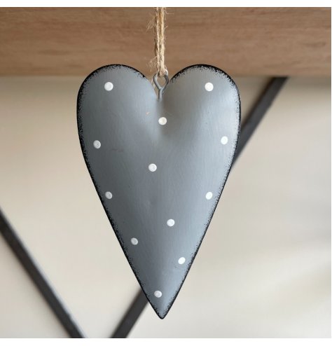 A hanging metal heart covered with a soft grey tone, distressed edge finish and added white dotty print 