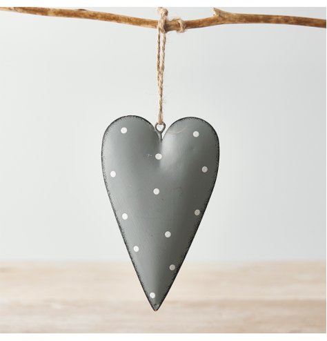 A hanging metal heart covered with a soft grey tone, distressed edge finish and added white dotty print 
