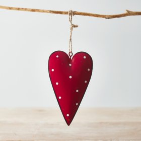 A red toned metal hanging heart with an overly distressed design and added white polka dot print to finish 