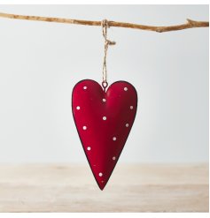 A red toned metal hanging heart with an overly distressed design and added white polka dot print to finish 