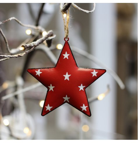 A hanging metal star covered with a soft red tone, distressed edge finish and added white dotty print 
