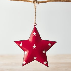 A red toned metal hanging star with an overly distressed design and added white star print to finish 