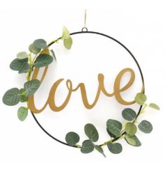 A chic and simple metal loop wreath, entwined with artificial eucalyptus foliage and set with a script love text 
