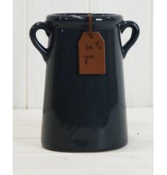 A deep navy hued ceramic vase featuring tapered ear handles and a leatherette tag to finish 