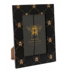 A sleek wooden picture frame with a Black and Gold tone and bee prints