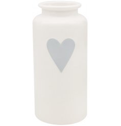 A small white vase with a grey heart decal