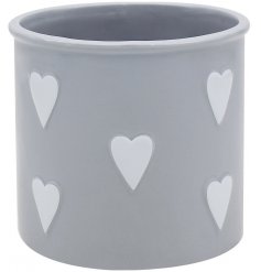 A large grey planter with heart decals