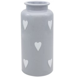 A small grey vase with heart decals