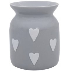A grey ceramic wax warmer with white heart decals