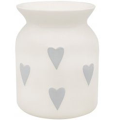 A white ceramic wax warmer with heart details