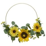 Sure to hang perfectly on any front door throughout the entire year, a half decorated ring wreath set with a bright sunf