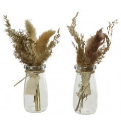 An assortment of stylish pampas grass displayed in a rope wrapped glass vase.