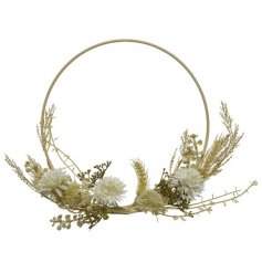 An elegant loop wreath dressed with an abundance of bohemian dried blooms and leaves.
