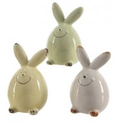 An Assortment of Three Porcelain Bunnies in White, Green and Yellow