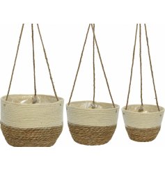 A set of 3 natural corn leaf hanging baskets in a natural and cream block design. Fully lined with rope hangers.