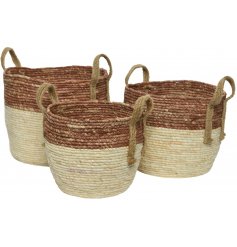 A set of 3 natural woven baskets with jute handles. Rustic in design with a bold stripe design.