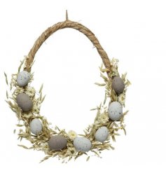 An egg shaped wreath, decorated with seasonal grasses, flowers and an added touch of eggs! 