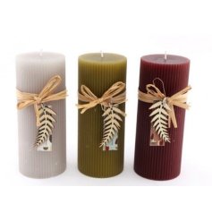 An assortment of three Ribbed Pilar candles, in Maroon Red and Burnt Orange
