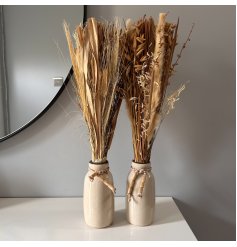 An Assortment of Bajra/Muni Grass Bouquets in a Beige Ceramic Vase