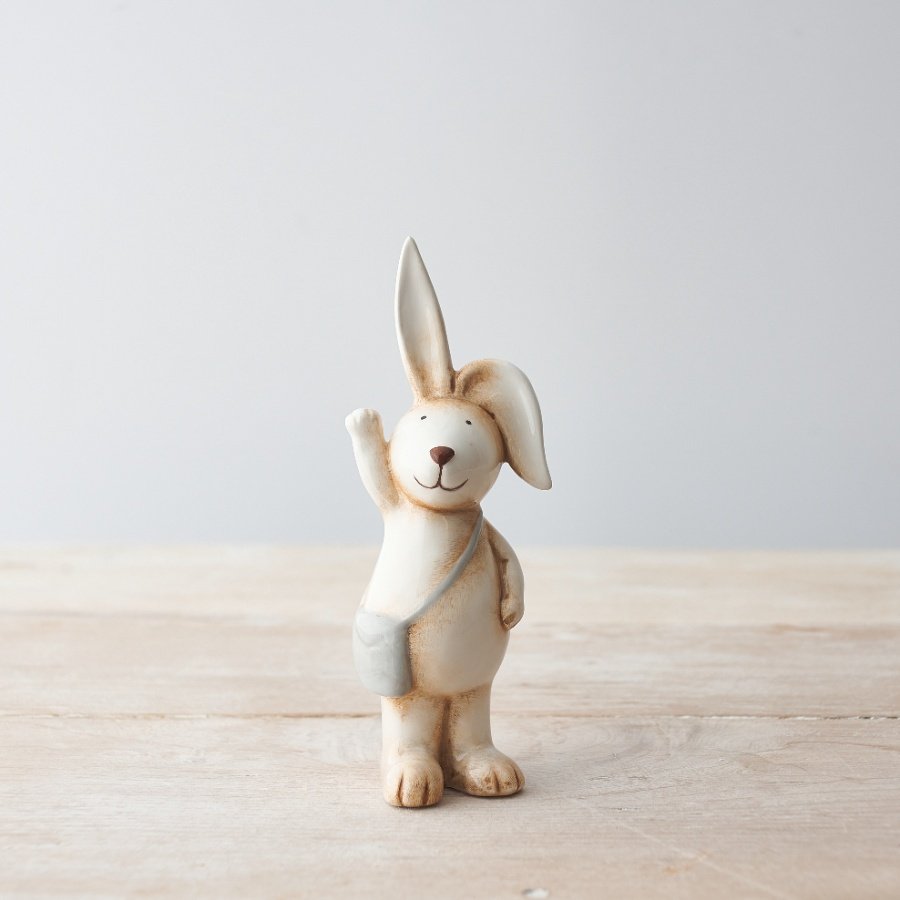 An adorable bunny decoration with cute flopsy ears and a grey satchel. 