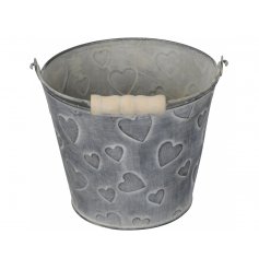 A Small Iron Planter with Heart Embossed Decal