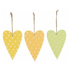 An assortment of 3 brightly coloured hanging wooden hearts. Each has a jute string hanger and is decorated with pattern