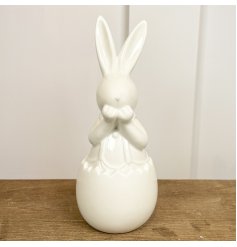 An Adorable White Ceramic Bunny Ornament in an Egg Shell