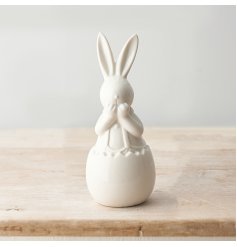 An Adorable White Ceramic Bunny Ornament in an Egg Shell