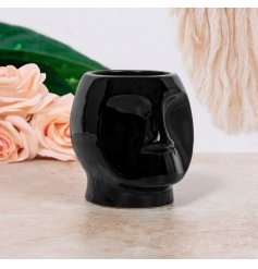 A Modern Styled Black Plant Pot in Face Design