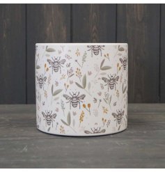 A lovely terracotta plant pot decorated with a charming bee and foliage design. Painted in subtle earthy hues. 