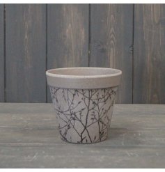 A Charming Earthy Plant Pot With Silhouette Detailing