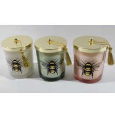 An assortment of 3 beautifully scented glass candle pots with a decorative lid and luxurious bee design. 
