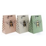 An assortment of 3 pastel coloured gift bags. Complete with a luxurious shimmering gold bee motif. With matching tag.