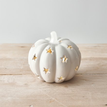 A chic seasonal pumpkin decoration with white star detailing and LED lights. 