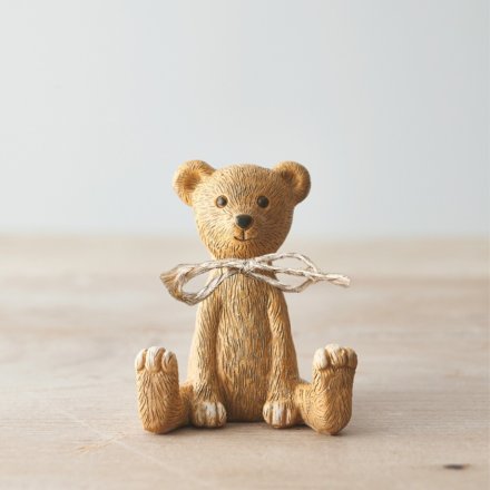 A rustic sitting bear ornament with a jute string bow. A gorgeous gift item and interior accessory.