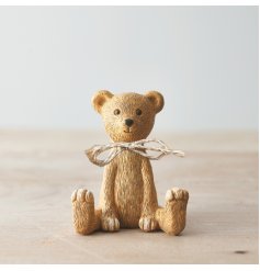 A charming sitting bear decoration with a rustic jute bow. 