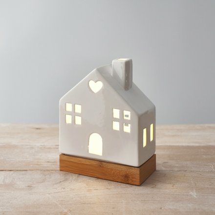 A charming ceramic house decoration in white