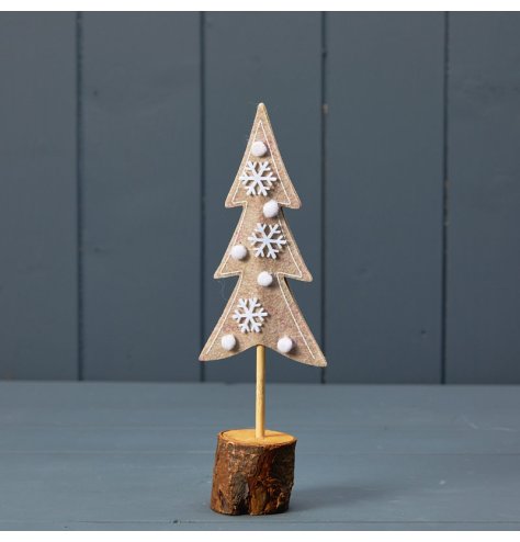 A stylish and unique felt Christmas tree with white pom poms and snowflakes.