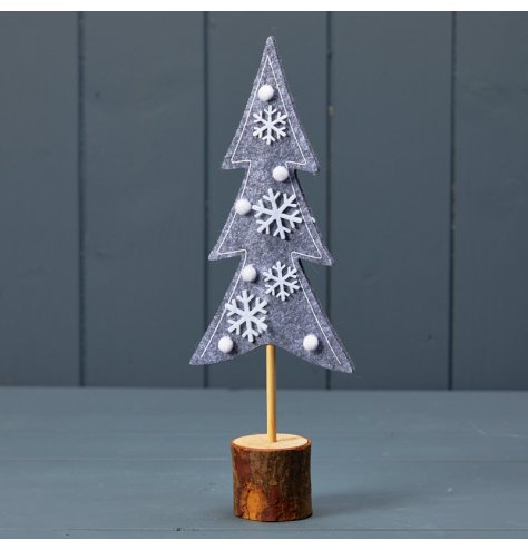 A chic Christmas tree made from felt, stood upon a natural wooden bark base. Decorated with snowflakes and pom poms. 
