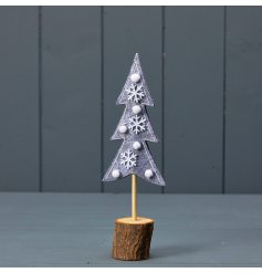 A chic felt Christmas tree stood upon a natural wooden bark base. Decorated with wooden snowflakes and white pom poms. 
