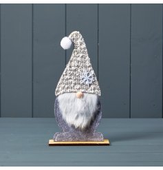 A charming wooden Santa decoration with grey felt body, faux fur beard and a tall snowflake hat. 