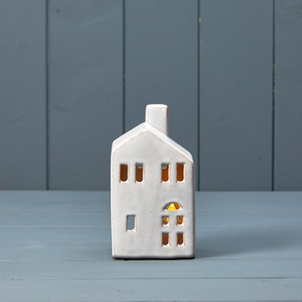 A chic ceramic t-light house with a white reactive glaze finish. A must have interior accessory this season.